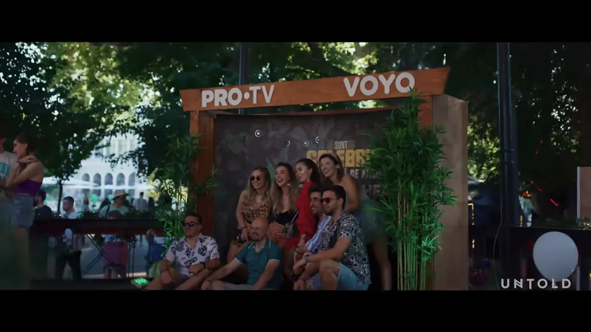 A group of people pose at a branded experience at Untold Festival