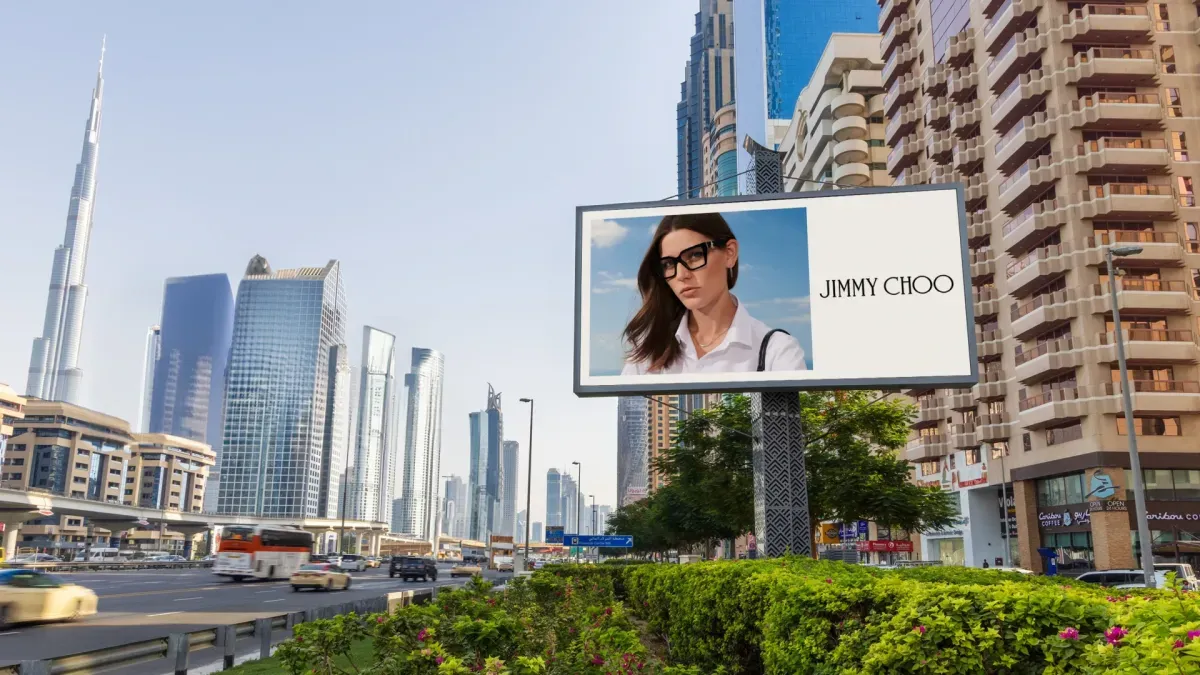 Jimmy Choo Eyewear billboard advertising on Sheikh Zayed Road in Dubai, with the Burj Khalifa visible in the background.