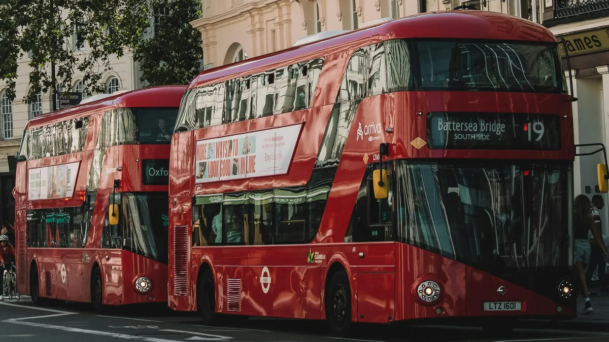 Two London buses on a street together