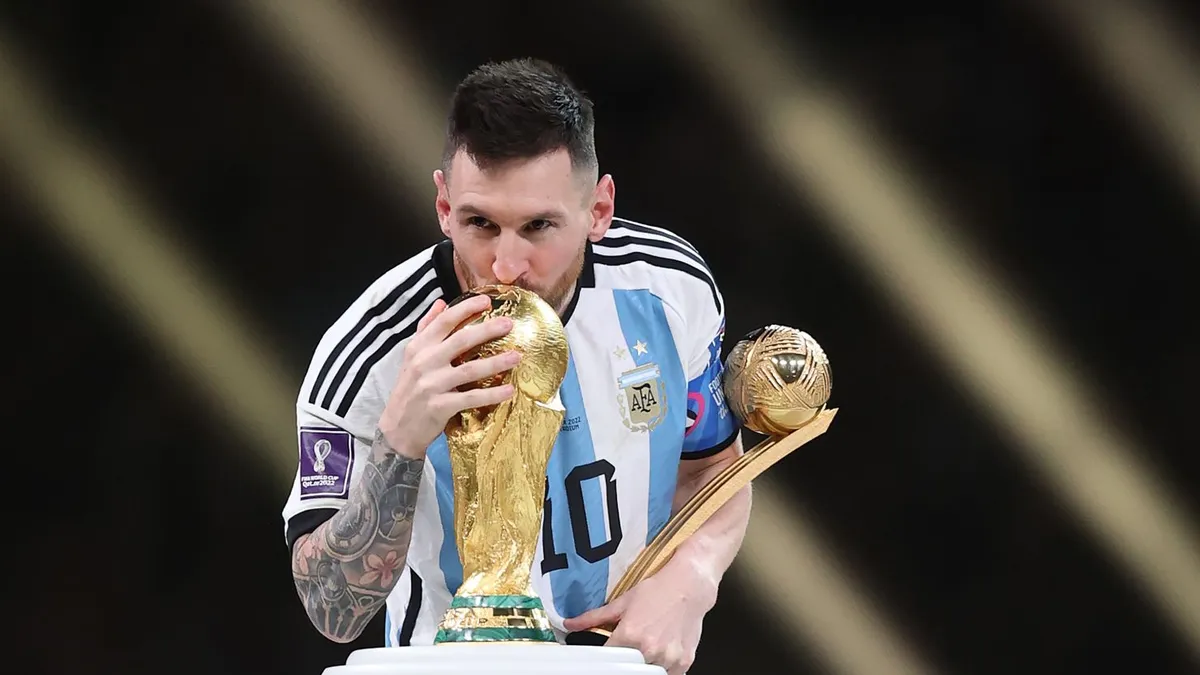 Lionel Messi with the FIFA World Cup trophy in 2022 - Media Agency Group